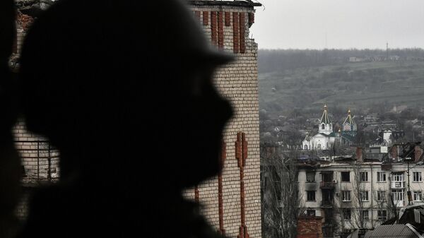 A service member of Russia's private military company Wagner Group inspects a building in Artemovsk, also known as Bakhmut, as Russia's military operation in Ukraine continues, Donetsk People's Republic, Russia. - Sputnik Africa