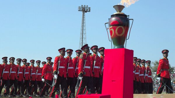 Malawi soldiers parade past by a burning anniversary candle during celebrations for the Malawian 50th independence anniversary at Civo stadium on July 6, 2014 in Lilongwe, Malawi.  - Sputnik Africa