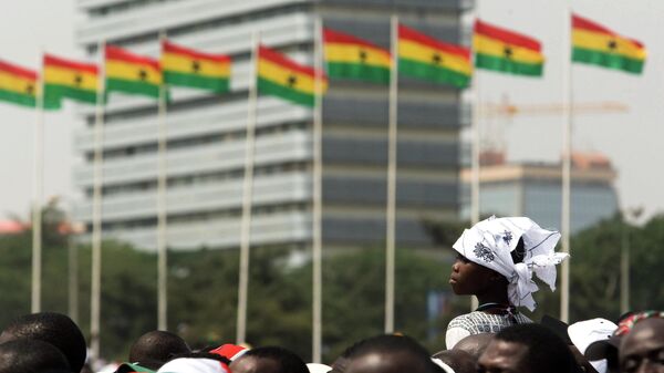 A girl sits on an adult's shoulders to get a better view as she waits among a crowd prior to the ceremony held for the inauguration of Ghana's new President John Atta Mills in Accra, Ghana Wednesday, Jan. 7, 2009.  - Sputnik Africa