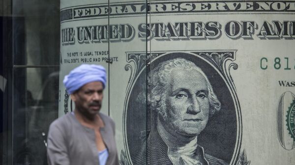 A man walks past a currency exchange shop displaying a giant US dollars banknote in downtown Cairo on November 3, 2016 - Sputnik Africa