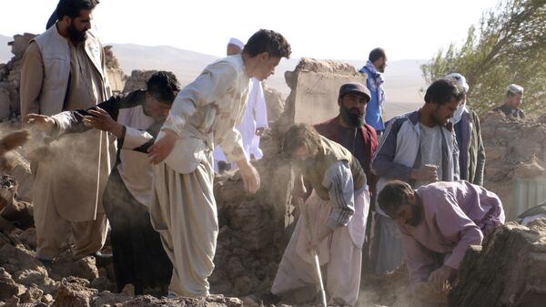People clear away rubble after an earthquake in the Zenda Jan district of Herat province in western Afghanistan. - Sputnik Africa