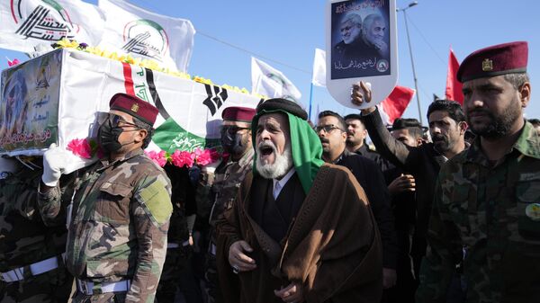 Members of an Iraqi Shiite militant group carry the coffin of an fighter with the Kataib Hezbollah militia, who was killed in a U.S. airstrike in Babil Province, during his funeral in Baghdad, Iraq, Tuesday, Dec. 26, 2023. ( - Sputnik Africa