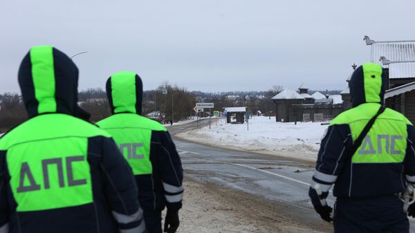 Traffic police officers block a road near the crash site of an Il-76 transport plane of the Russian air forces with 65 Ukrainian prisoners who were being transported for exchange, six crew members and three accompanying persons, in Belgorod region, Russia, on Wednesday, January 24, 2024. The plane was shot down by Ukraine, according to the Russian Defence Ministry, and all people on board were killed. - Sputnik Africa