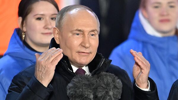 Russian President Vladimir Putin attends a rally-concert on Moscow's Red Square to mark the tenth anniversary of Crimea's reunification with Russia on March 18, 2024. - Sputnik Africa