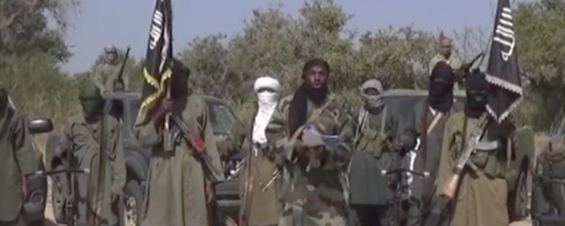 This Friday Oct. 31, 2014 image taken from video by Nigeria's Boko Haram terrorist network, the leader of Nigeria's Islamic extremist group Boko Haram, center, has denied agreeing to any cease-fire with the government and said Friday more than 200 kidnapped schoolgirls all have converted to Islam and been married off. - Sputnik Africa, 1920, 30.11.2024