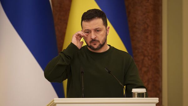 Ukraine's President Volodymyr Zelensky wipes his eye during a press conference with Finland's President Alexander Stubb, in Kiev, Ukraine - Sputnik Africa