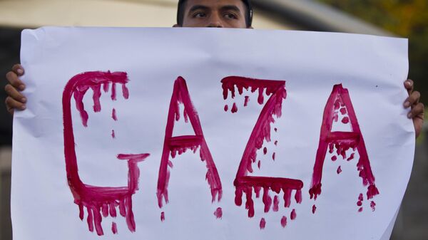 A demonstrator holds up a sign during a protest outside the US embassy in Managua, Nicaragua, Monday, Nov. 19, 2012. People protested against the Israeli military operations in Gaza Strip.  - Sputnik Africa