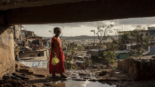 A young girl walks in the Kaweni slum on the outskirts of Mamoudzou, in the French Indian Ocean island of Mayotte, Thursday, Dec. 19, 2024, after Cyclone Chido.  - Sputnik Afrique