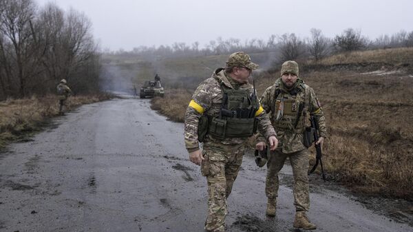 A Ukrainian brigade commander Dyadya Roma speaks to his comrade at a frontline in the Kharkov region, Ukraine, Saturday, Dec. 24, 2022 - Sputnik Africa