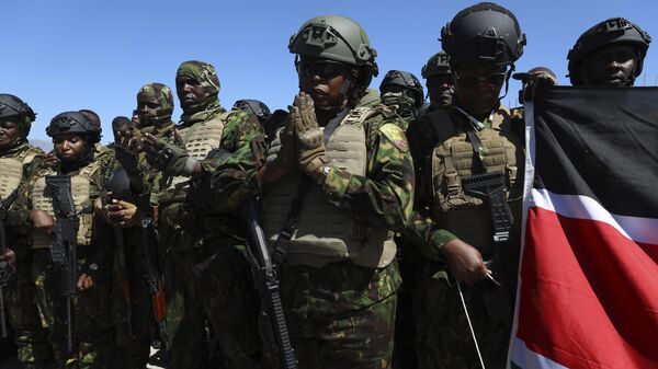 Kenyan police, who are part of a UN-backed multinational force, pray on the tarmac after landing at the Toussaint Louverture International Airport in Port-au-Prince, Haiti, Thursday, Feb. 6, 2025. - Sputnik Africa